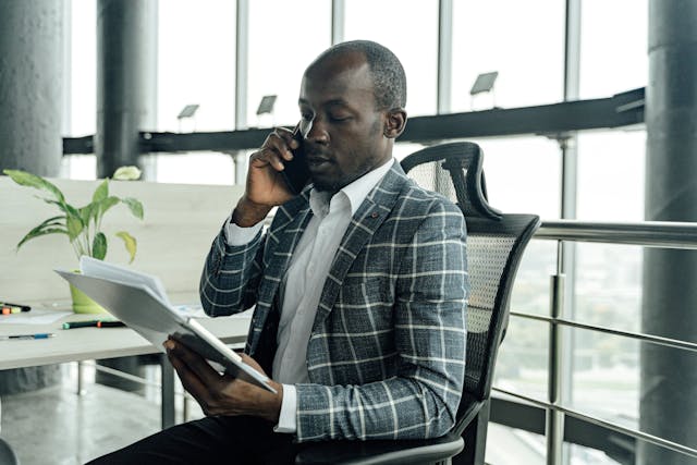 property%20manager%20talking%20on%20the%20phone%20and%20looking%20over%20documents property%20manager%20talking%20on%20the%20phone%20and%20looking%20over%20documents